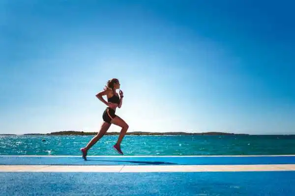 Woman running showing strong leg muscle Uttoxeter